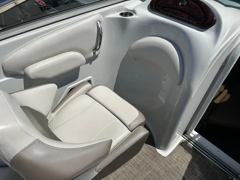 Slide: The Image of 2019 Crownline 236 SC boat interior with beige seating and modern design. - 11