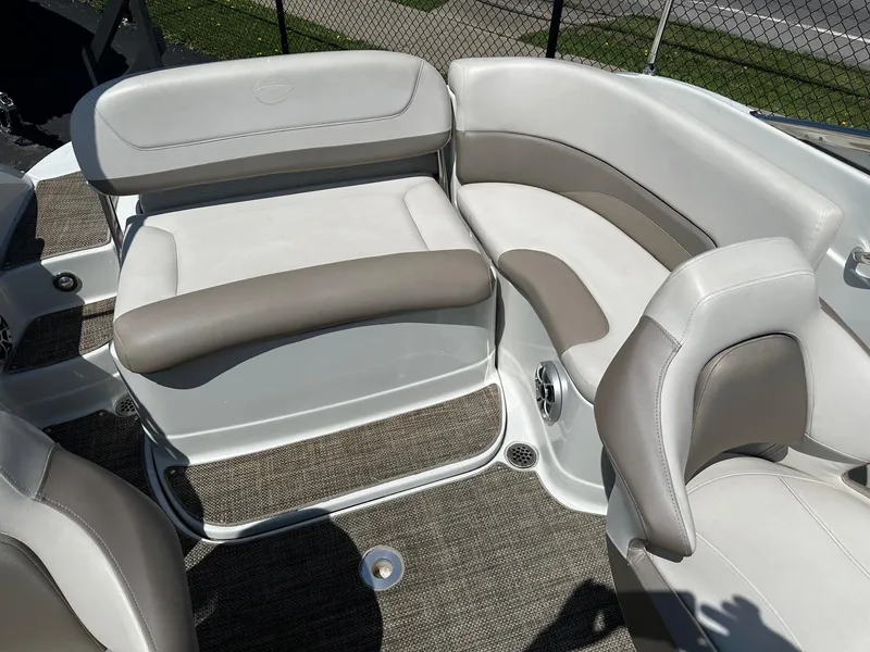 Slide: The Image of 2019 Crownline 236 SC boat interior with beige and white seating, carpeted floor. - 9