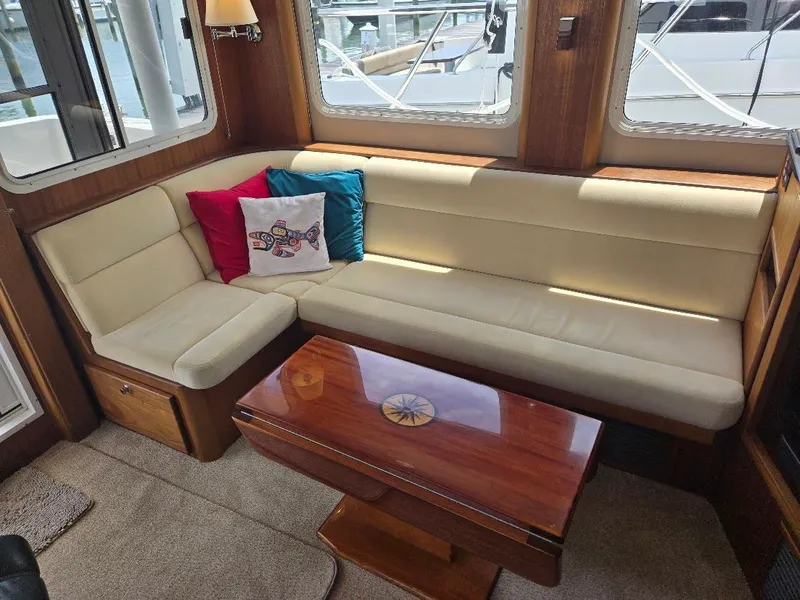 Slide: The Image of Luxurious interior of 2010 American Tug 49 Limited with beige seating and wooden table. - 17