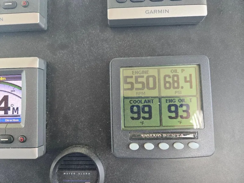 Slide: The Image of Engine control panel displaying RPM, oil pressure, coolant, and oil temperature on a 2010 American Tug 49 Limited. - 38