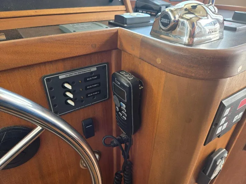 Slide: The Image of Control panel of a 2010 American Tug 49 Limited with steering wheel and communication device. - 44