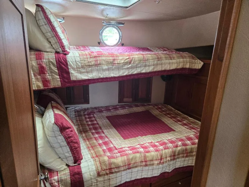 Slide: The Image of Bunk beds with plaid bedding in a 2010 American Tug 49 Limited cabin. - 6
