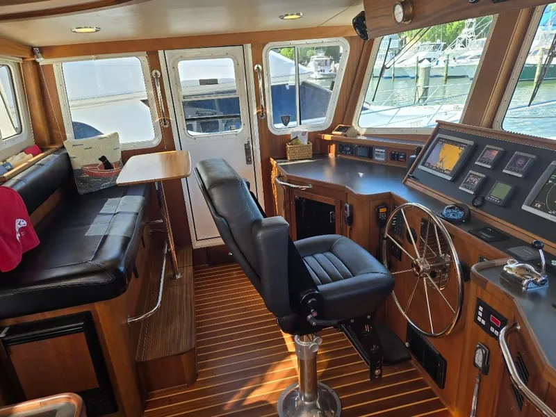 Slide: The Image of Pilothouse of 2010 American Tug 49 Limited with leather seating and navigation equipment. - 7