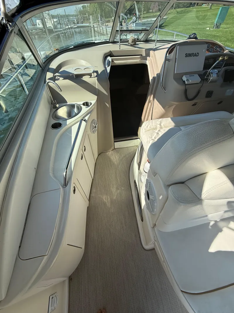 Slide: The Image of 1999 Sea Ray 340 Sundancer interior with helm, seating, and control panel. - 13