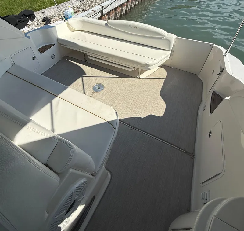 Slide: The Image of 1999 Sea Ray 340 Sundancer boat interior with beige seating and carpeted floor. - 14