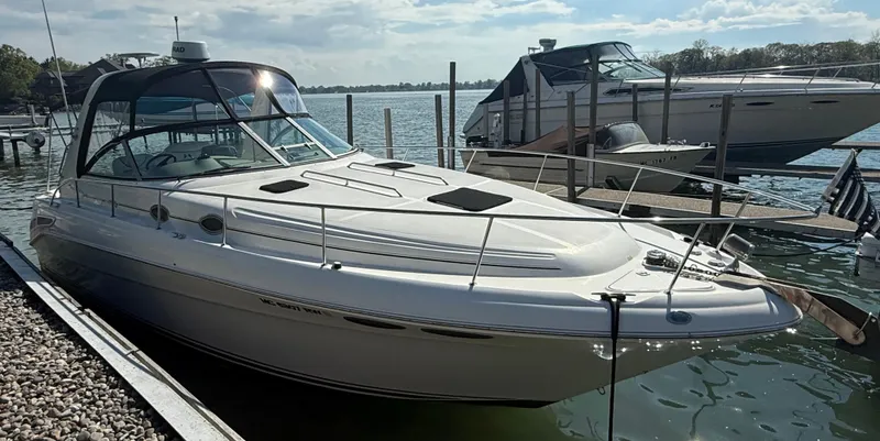 Slide: The Image of 1999 Sea Ray 340 Sundancer docked at marina, sunny day, calm water. - 2