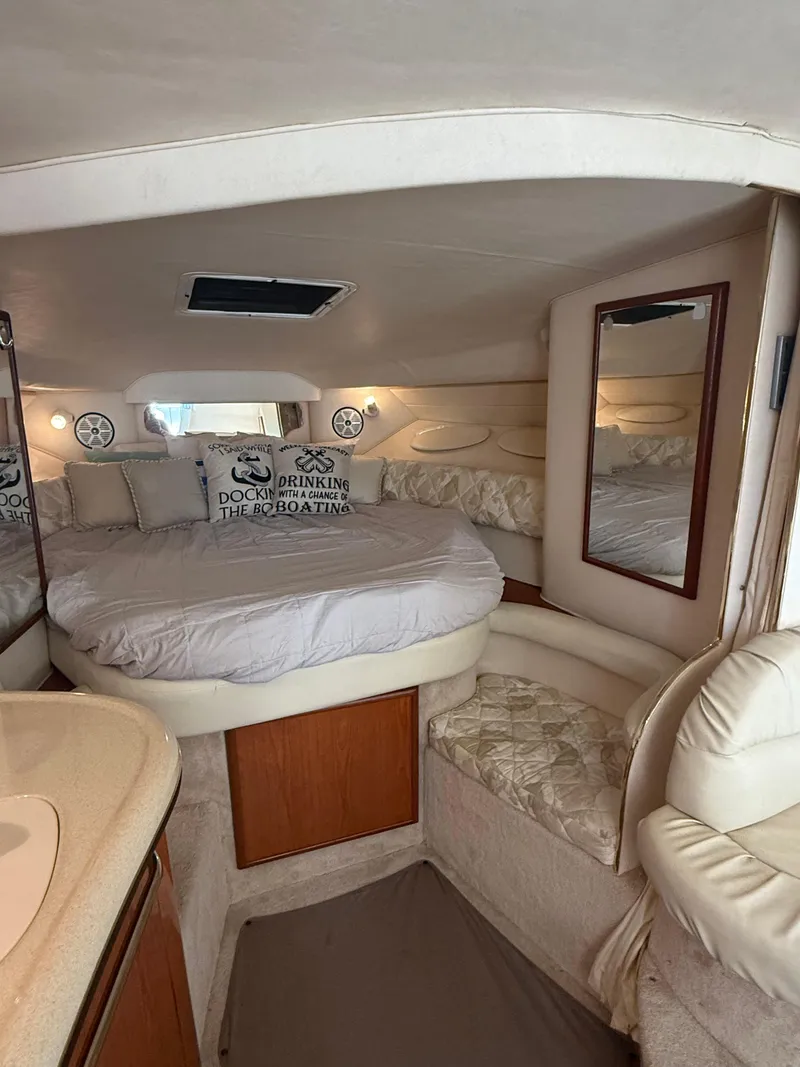 Slide: The Image of Interior of 1999 Sea Ray 340 Sundancer with cozy bed and nautical decor. - 29