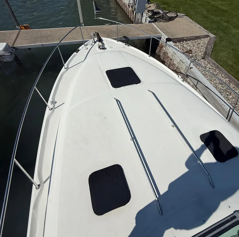 Slide: The Image of 1999 Sea Ray 340 Sundancer boat docked, top view of bow and deck. - 3