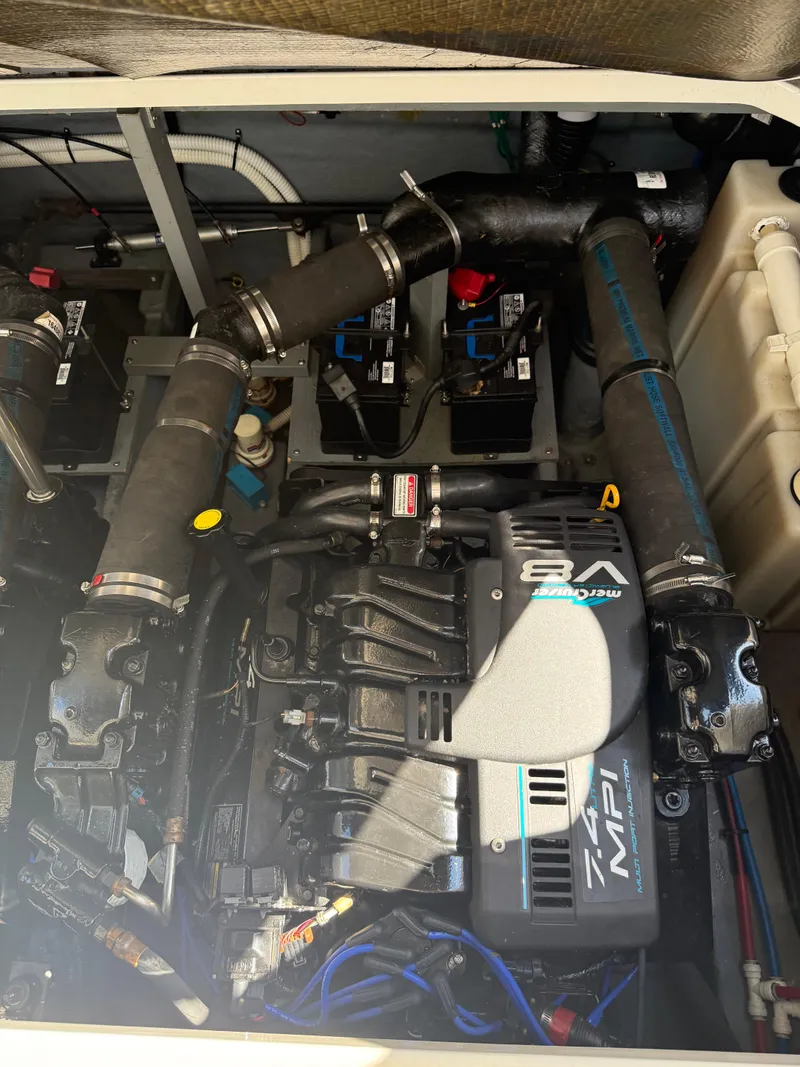 Slide: The Image of Engine compartment of a 1999 Sea Ray 340 Sundancer boat, featuring a well-maintained engine. - 31