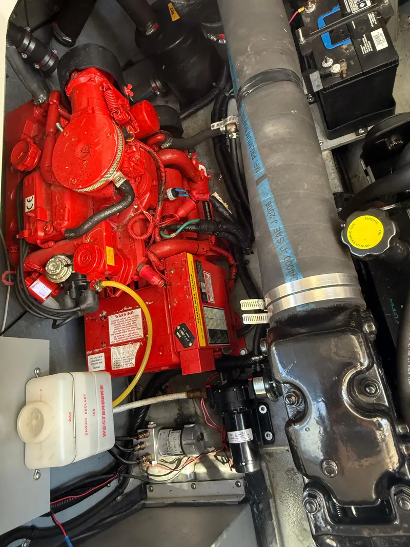 Slide: The Image of Engine compartment of a 1999 Sea Ray 340 Sundancer with visible red engine components. - 34
