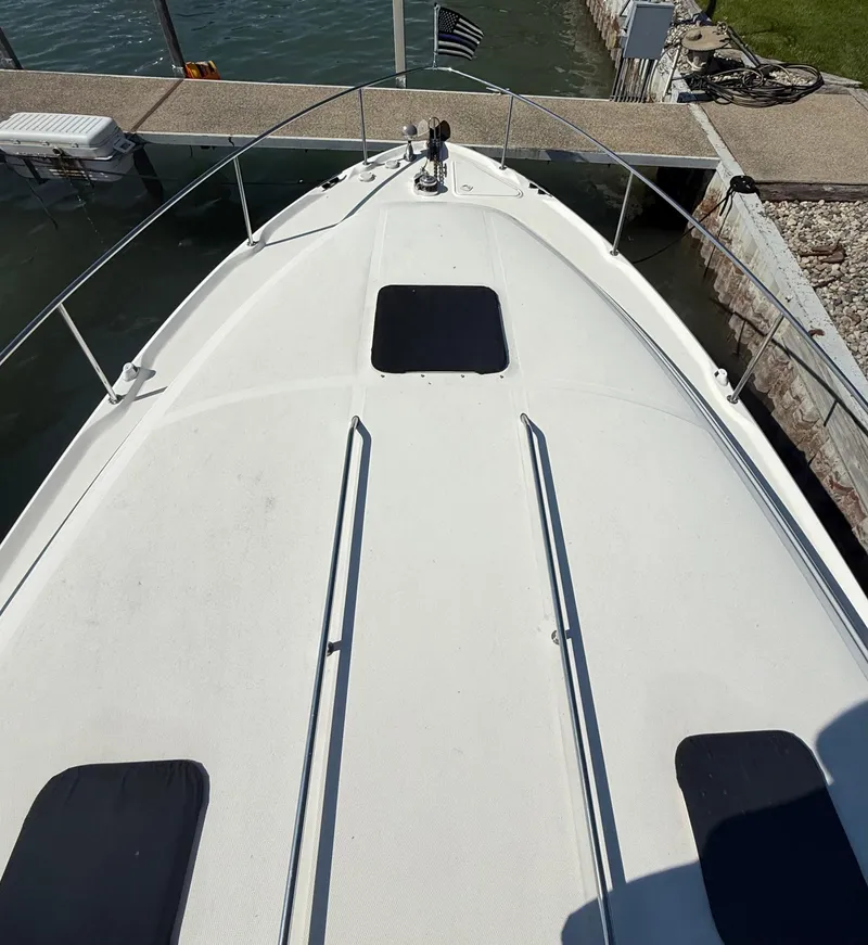 Slide: The Image of 1999 Sea Ray 340 Sundancer boat docked, view of bow and deck. - 4