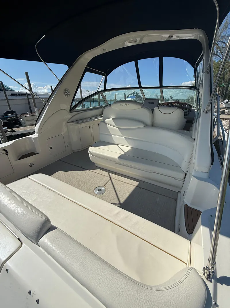 Slide: The Image of 1999 Sea Ray 340 Sundancer boat interior with white seating and canopy. - 8