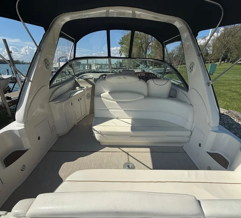 Slide: The Image of 1999 Sea Ray 340 Sundancer boat interior with white seating and canopy. - 9