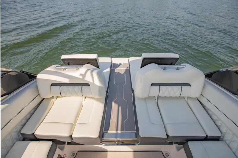 Slide: The Image of 2021 Regal LS6 boat with luxurious white seating on a calm lake. - 15