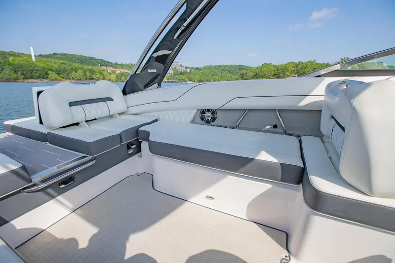 Slide: The Image of Luxurious seating area on a 2021 Regal LS6 boat, with scenic lake view. - 17