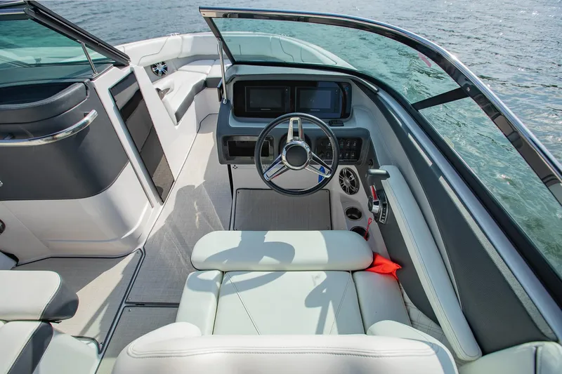 Slide: The Image of 2021 Regal LS6 boat interior with modern dashboard and steering wheel on water. - 20