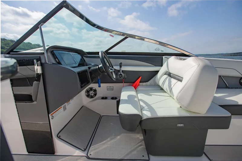Slide: The Image of 2021 Regal LS6 boat interior with white seating and modern dashboard design. - 21