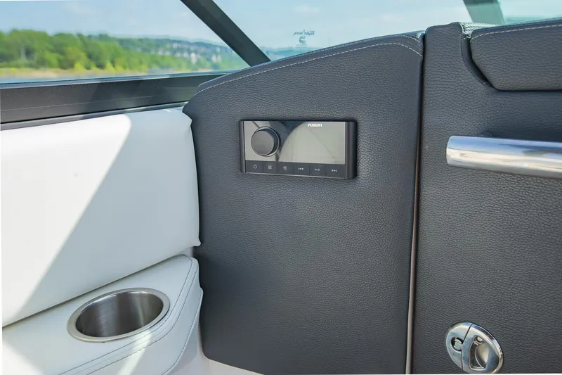 Slide: The Image of Interior of 2021 Regal LS6 boat with control panel and cup holder. - 30