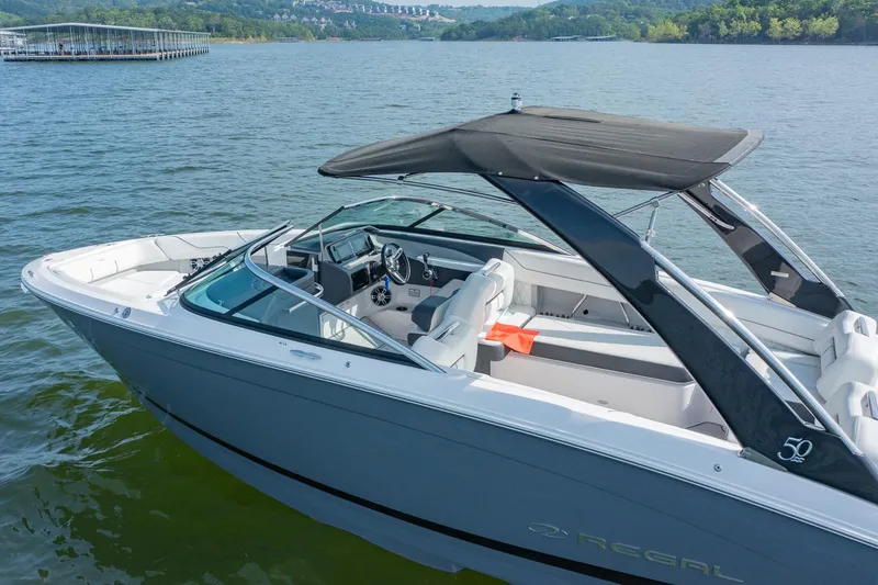 Slide: The Image of 2021 Regal LS6 boat on a lake, featuring sleek design and spacious seating. - 4