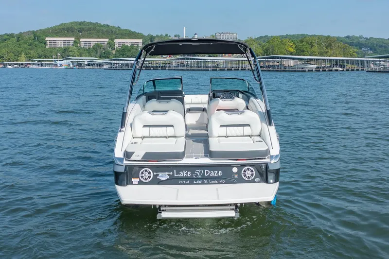 Slide: The Image of 2021 Regal LS6 boat on a lake, featuring spacious seating and sleek design. - 5