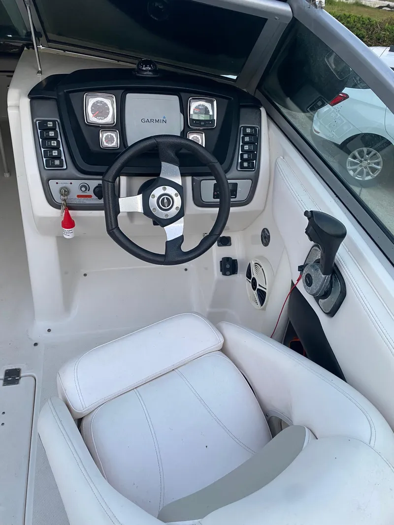 Slide: The Image of 2008 Chaparral Sunesta 244 boat cockpit with steering wheel and Garmin navigation system. - 13