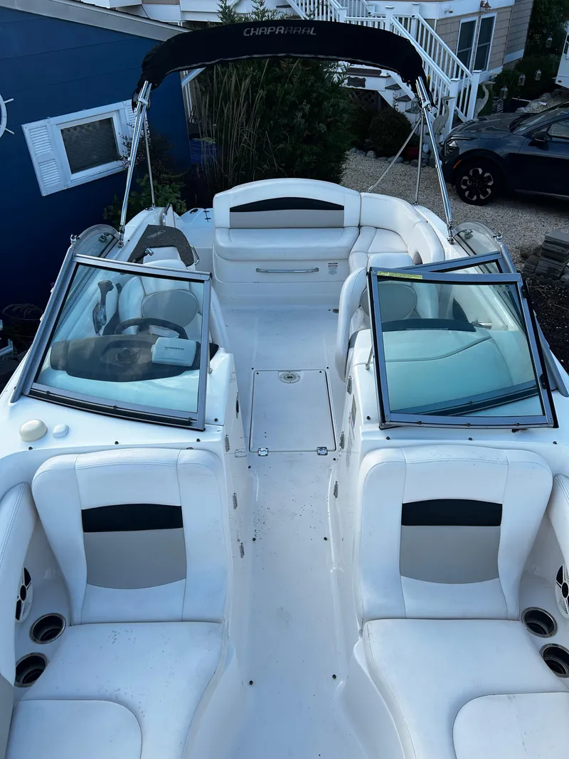 Slide: The Image of 2008 Chaparral Sunesta 244 boat interior with white seating and dual windshields. - 24