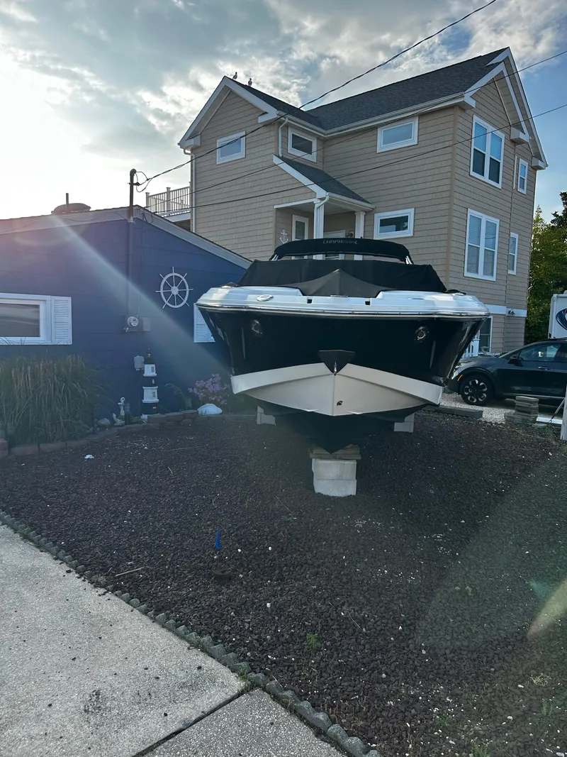Slide: The Image of 2008 Chaparral Sunesta 244 boat displayed in front of a house on a sunny day. - 27