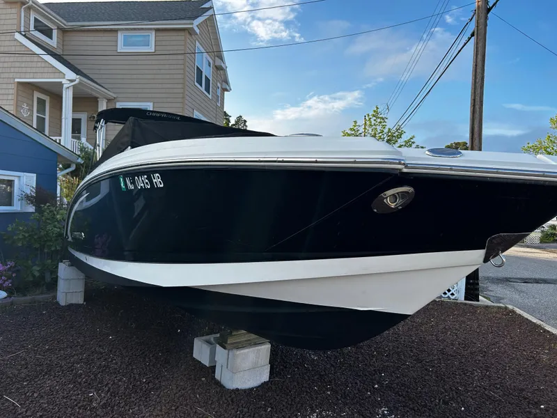 Slide: The Image of 2008 Chaparral Sunesta 244 boat on display near a house, clear sky background. - 3