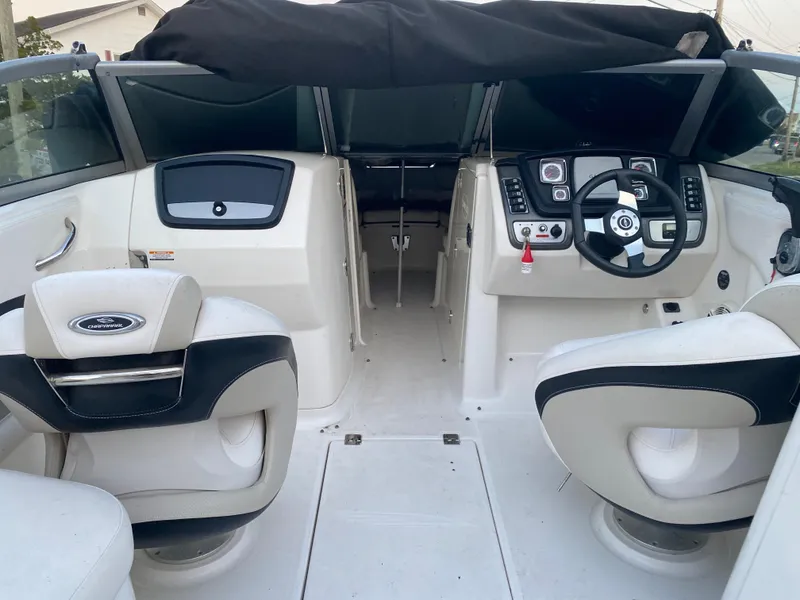 Slide: The Image of 2008 Chaparral Sunesta 244 boat interior with steering wheel and seating. - 7