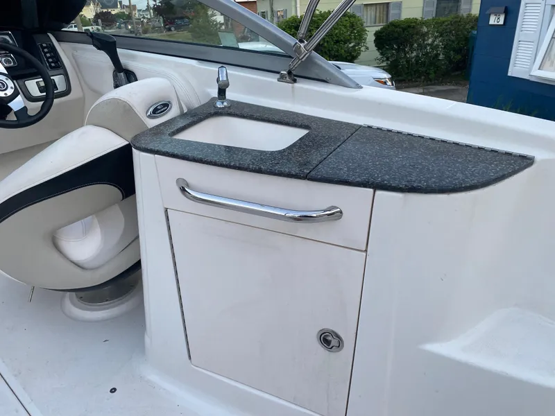 Slide: The Image of 2008 Chaparral Sunesta 244 boat interior with sink and seating area. - 9