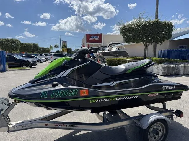 Slide: The Image of 2018 Yamaha WaveRunner EX jet ski on trailer, parked outdoors under a sunny sky. - 1