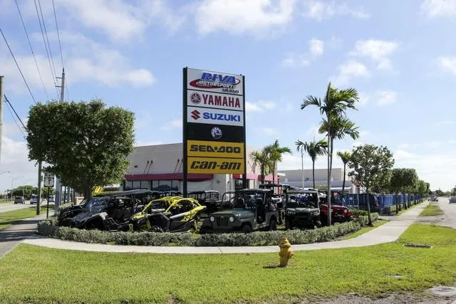 Slide: The Image of Outdoor display of Yamaha, Suzuki, Sea-Doo, and Can-Am vehicles at a dealership. - 13