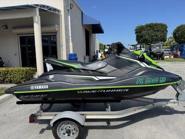 Slide: The Image of 2018 Yamaha WaveRunner EX on trailer, parked outside a building under clear blue sky. - 5