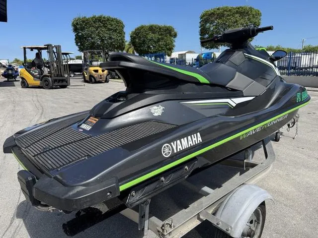 Slide: The Image of 2018 Yamaha WaveRunner EX jet ski on a trailer, black with green accents. - 6