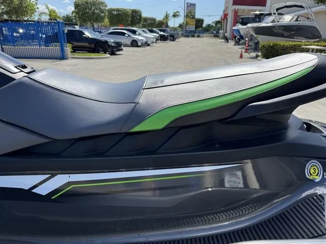 Slide: The Image of 2018 Yamaha WaveRunner EX with sleek black and green seat design, parked outdoors. - 9
