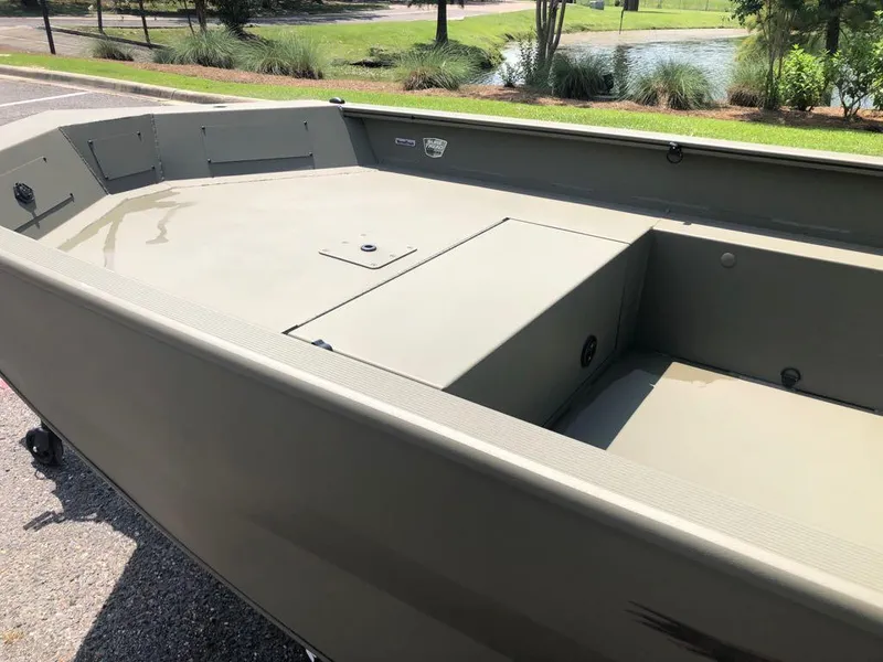 Slide: The Image of 2025 Tracker Grizzly 1650 T Prairie Wings Edition boat, interior view, parked outdoors. - 10