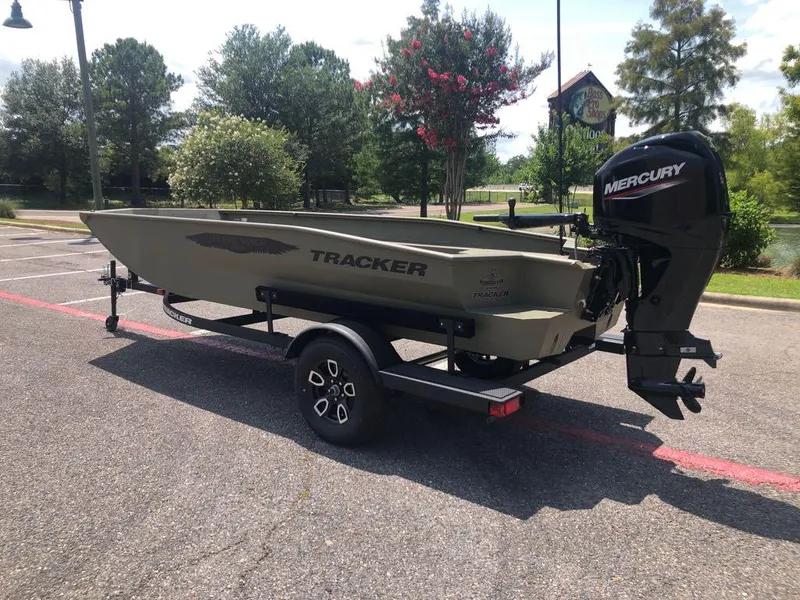 Slide: The Image of 2025 Tracker Grizzly 1650 T Prairie Wings Edition boat with Mercury engine in parking lot. - 2