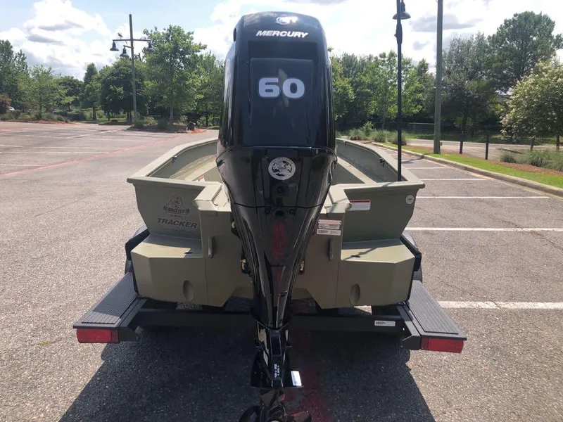Slide: The Image of 2025 Tracker Grizzly 1650 T Prairie Wings Edition boat with Mercury 60 engine in parking lot. - 3