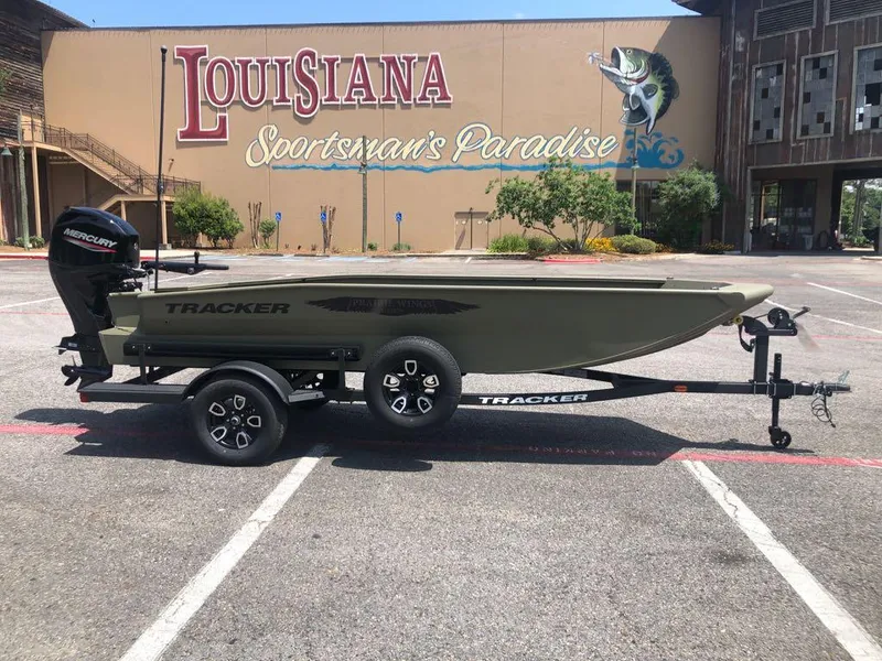 Slide: The Image of 2025 Tracker Grizzly 1650 T Prairie Wings Edition boat in parking lot, Louisiana Sportsman's Paradise. - 6