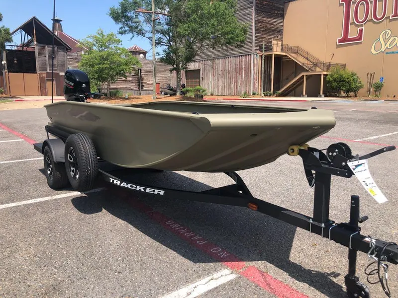Slide: The Image of 2025 Tracker Grizzly 1650 T Prairie Wings Edition boat on trailer in parking lot. - 7