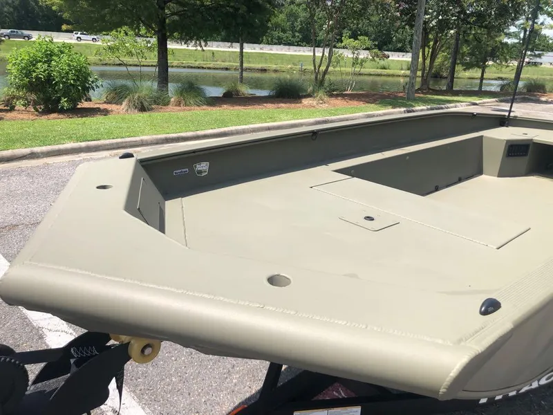 Slide: The Image of 2025 Tracker Grizzly 1650 T Prairie Wings Edition boat in a parking lot. - 9