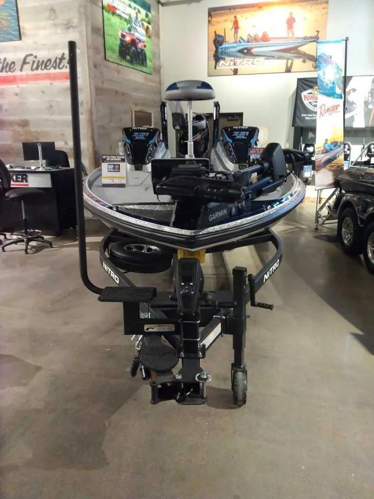 Slide: The Image of 2025 Nitro Z21 XL Pro boat displayed in showroom with Garmin equipment. - 7