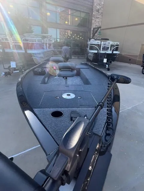 Slide: The Image of 2025 Tracker Super Guide V-16 T fishing boat displayed outdoors. - 2