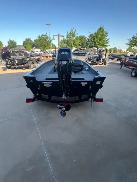 Slide: The Image of 2025 Tracker Super Guide V-16 T boat with 40 HP engine, parked outdoors. - 4