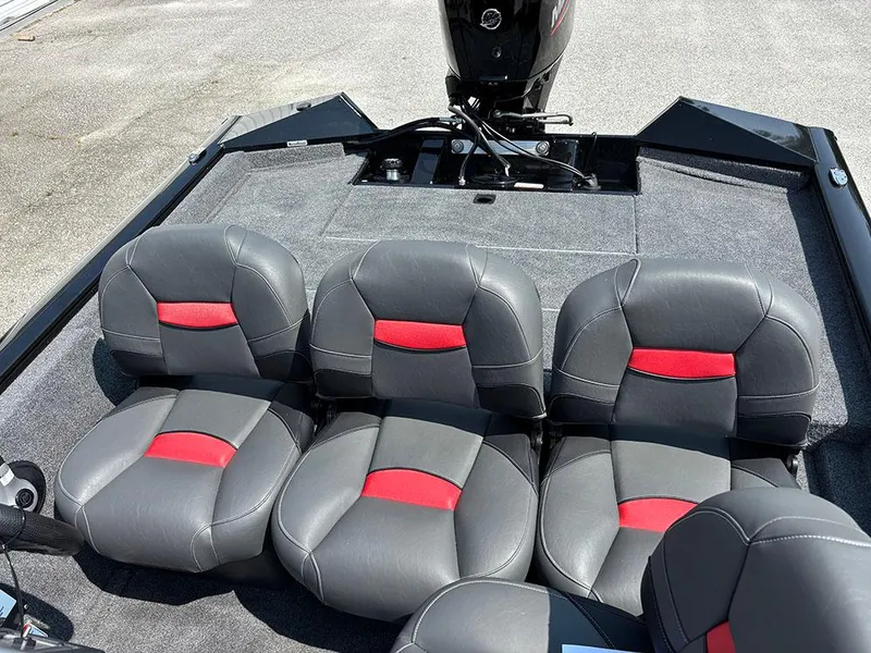 Slide: The Image of 2025 Tracker Pro Team 175 Crappie Edition boat seats with red accents and motor. - 14