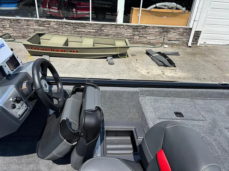 Slide: The Image of 2025 Tracker Pro Team 175 Crappie Edition boat interior with steering wheel and seating. - 15