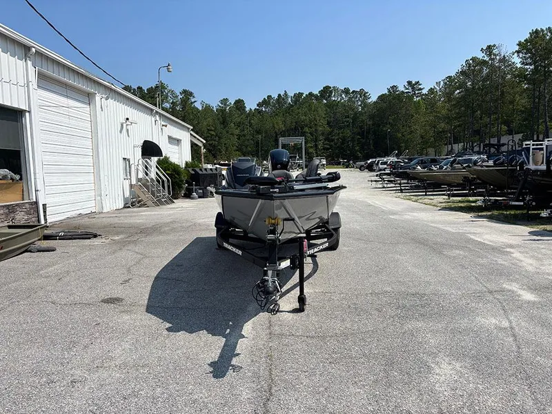 Slide: The Image of 2025 Tracker Pro Team 175 Crappie Edition boat parked outdoors near a warehouse. - 4