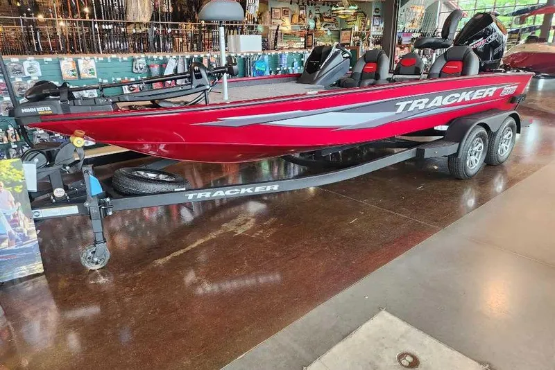 The Image of 2025 Tracker Savage 215 boat in showroom, red exterior, on trailer. - 0