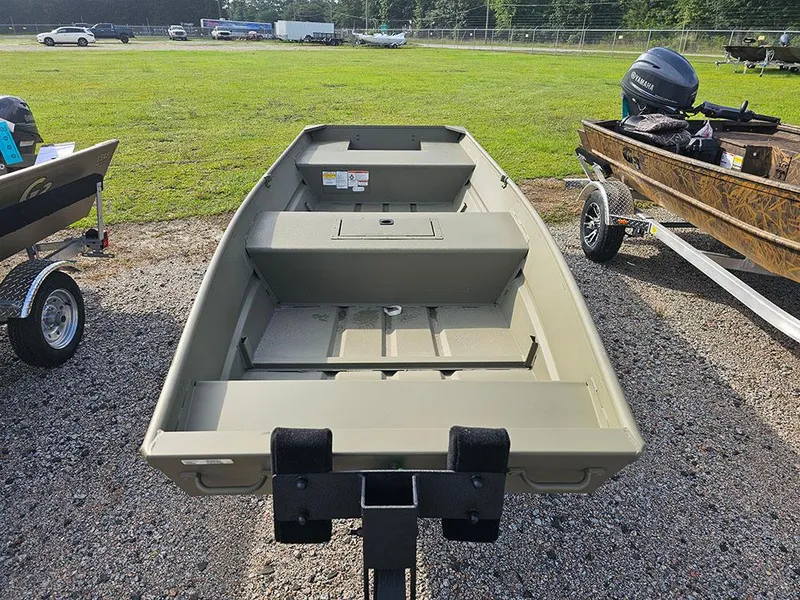 Slide: The Image of 2025 Tracker Grizzly 15 Jon boat on trailer, parked on gravel near grassy area. - 5