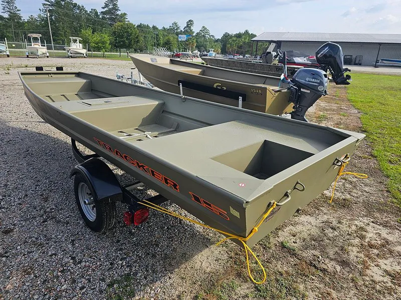 Slide: The Image of 2025 Tracker Grizzly 15 Jon boat on trailer, parked outdoors. - 7
